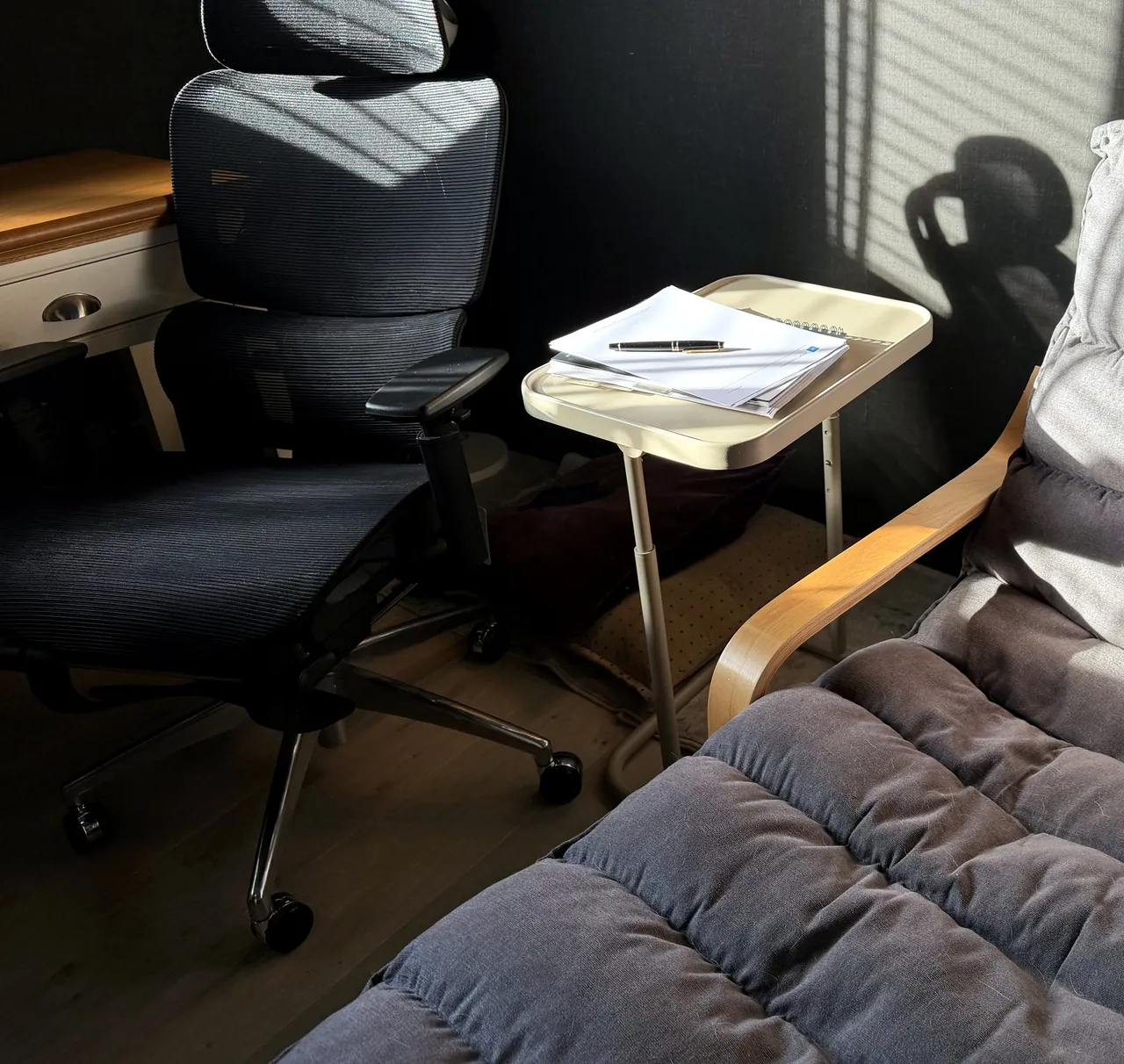 A quiet room with two chairs and a small table between them, in afternoon sun